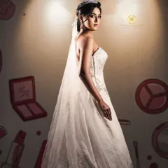 A full-length portrait of the bride in her beautiful strapless gown, complete with a long, flowing veil. This is a classic and timeless bridal look available for rent.