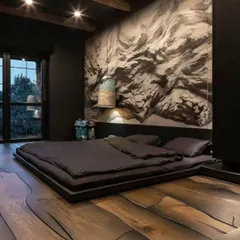A dramatic and moody bedroom with dark walls and a striking abstract mural. The low-profile platform bed and unique wooden flooring with a flowing grain pattern create a bold, artistic statement.