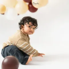 A candid glance back at the camera. I let babies explore the space, which allows for natural and authentic milestone portraits.