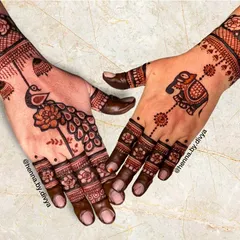 A royal design featuring a majestic peacock on one hand and a beautifully decorated elephant on the other. These symbolic motifs are perfect for celebrating a wedding or special occasion.