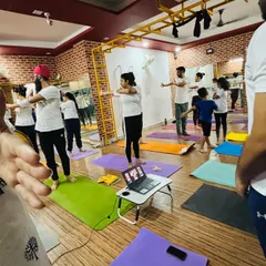 Our community comes together for International Yoga Day, with online students joining the in-person class for a unified practice.