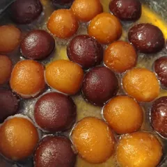 Our gulab jamuns soaking in fragrant, sweet syrup. We make them from scratch with a khoya base, ensuring they are incredibly soft and melt in your mouth. This is comfort food at its best.