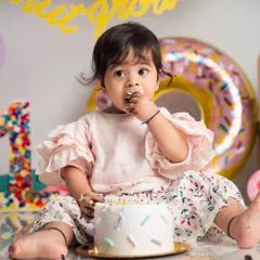 Getting a first taste of birthday cake is a serious business. We love capturing these curious, frosting-filled expressions during our donut-themed cake smash sessions.