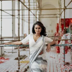 An editorial shoot that uses a raw, industrial construction site as a backdrop. The contrast between the elegant saree and the unfinished setting creates a modern and edgy portrait.