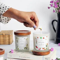 A simple match strike is all it takes to bring a touch of freshness into your home. Here, I'm lighting my Strawberry & Champagne candle, which sits beautifully alongside the Jasmine fragrance, both featuring frosted glass and Indian Rosewood lids for a minimalist look.
