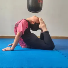 A young student demonstrates impressive flexibility, a key component of our training program. Flexibility helps in executing high kicks and preventing injuries.