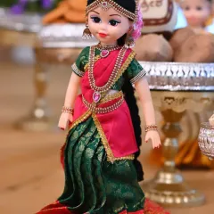 A close-up of a custom-dressed doll used in my seer plate decorations. These dolls add a unique and personal touch to the offering plates.