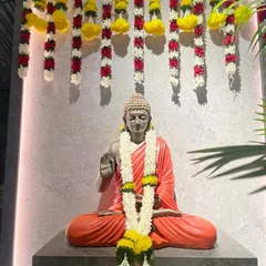 Our serene Buddha statue decorated with flower garlands for Diwali. We believe in celebrating together as a community and creating a space that nurtures both body and mind.