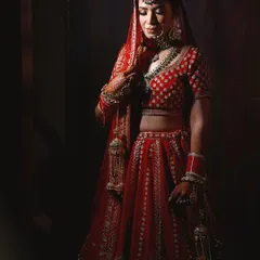 A full-length bridal portrait using dramatic lighting. This technique creates a timeless and elegant image, highlighting the bride in her magnificent wedding dress.