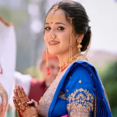 The complete Maharashtrian bridal look, from the Mundavalya across her forehead to the intricate henna on her hands. The makeup is designed to last through all the rituals, keeping her looking fresh and radiant.