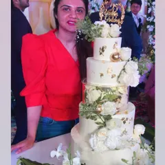 My first five-tier cake! This magical white and gold creation was for a 25th anniversary. It featured floating tiers with lights, delicate gold leaf, and a cascade of white roses. The top tiers were chocolate mousse and the bottom was classic pineapple.