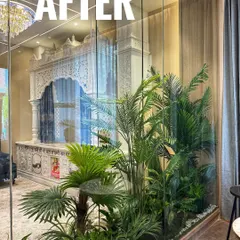 This is how we transform challenging indoor spaces. For this home's pooja room, enclosed in glass with no direct sunlight, we created a tropical paradise using high-quality artificial palms and foliage for a vibrant, everlasting look.
