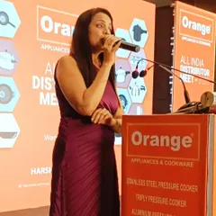Addressing the attendees at the Orange Cookware distributor meet. It's crucial to communicate the company's profile, product knowledge, and new schemes in a way that is clear, engaging, and interactive.