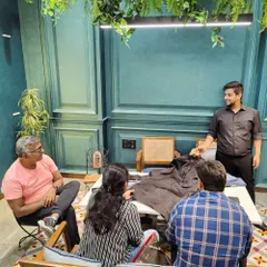A bespoke tailoring consultation for a client celebrating his 25th wedding anniversary. Our founder, Ujjwal, is seen here discussing fabric options and design possibilities with the family.