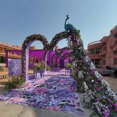 For a unique and royal touch, I created this stunning wedding entrance featuring a peacock made entirely of purple and white flowers. The floral arches and matching printed aisle create a cohesive and unforgettable welcome for your guests.