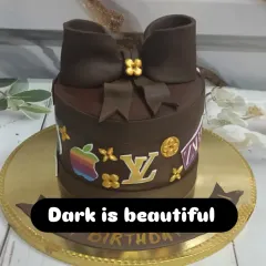 A luxurious dark chocolate cake themed around high-end brands like Louis Vuitton and Apple. The rich chocolate fondant bow is the perfect finishing touch.
