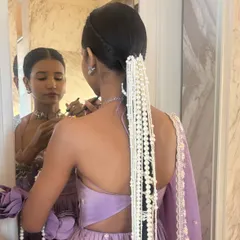 For this unique look, I created a long, sleek braid and adorned it with cascading strings of pearls. The hair is parted in the center and braided tightly for a clean, modern take on a traditional accessory.