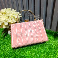 This pink, vertically striped box clutch with a gold handle is a chic and structured accessory for any party look.