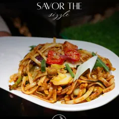 A close up of my Udon Noodles tossed in a vibrant vegetable yellow sauce. The thick, chewy noodles are combined with fresh, crisp vegetables, offering a comforting and flavourful dish from my Japanese Teppanyaki menu.