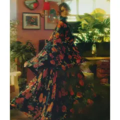 A motion-blur shot from 'The Wait', capturing the swirl of the floral dress. This technique visually represents the feeling of being lost in a memory, where details are soft and dreamlike.