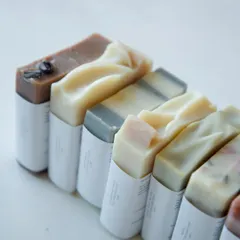 A lineup of the assorted soaps packed for the baby shower, showing the variety of natural colors.
