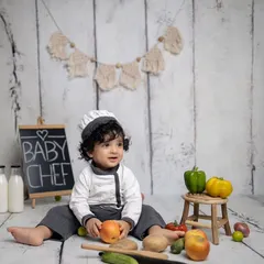 A happy moment from the baby chef photoshoot. His curly hair and bright smile make this shot extra special.