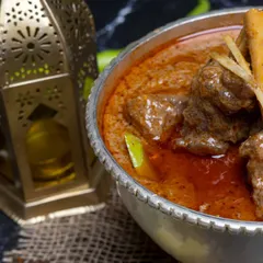 A close-up of our Nalli Nihari, showcasing the tender meat falling off the bone into a rich, spicy gravy. It's the ultimate comfort food.