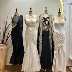 Black and white elegance. Our new collection features a range of stunning outfits in classic monochrome, including draped sarees, lace gowns, and embellished cape sets.