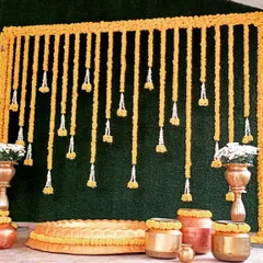 For a classic Haldi ceremony, we designed this beautiful backdrop using traditional marigold garlands and authentic brass and copper urulis, giving it a warm and auspicious feel.