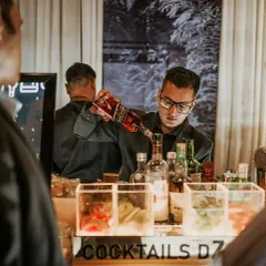 Focused and professional, our bartender pours a drink for a guest. We ensure our team is always attentive, providing top quality service even during the busiest moments of a party.