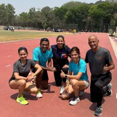 The team on the track with Coach Brinston. He is hands-on with his training, guiding athletes of all levels to achieve their best.