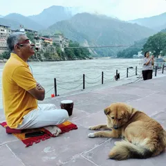 I find a moment of quiet contemplation by the Ganges in Rishikesh, accompanied by a friendly local dog. The practice of meditation is not confined to a room; it can be done anywhere, connecting us to our surroundings.