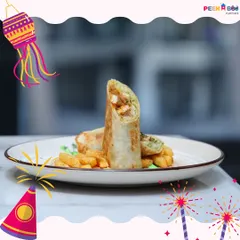 A freshly prepared shawarma wrap, grilled to perfection and served with a side of crispy fries. The wrap is generously filled, making it a wholesome and satisfying meal for any time of day.