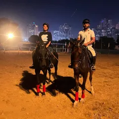 Our arena transforms after sunset, offering a unique location for a romantic couple's photoshoot. The dramatic glow of the Noida cityscape provides a stunning urban equestrian backdrop.