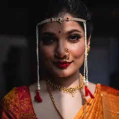Another striking portrait of the Maharashtrian bride. The play of light and shadow across her face adds depth and drama to the image.