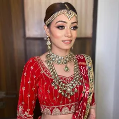 A profile shot highlighting the intricate details of the eye makeup and the smooth, long-lasting finish of Bhavika's bridal look.