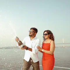 A celebratory moment on a private yacht in Goa, with champagne spray catching the sunlight. These are the fun, candid moments that make a luxury pre-wedding shoot so memorable.