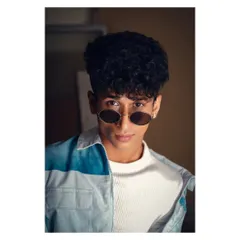 A cool, confident headshot for a male model's portfolio. The sunglasses and direct gaze create a modern, stylish look, while the studio lighting adds a professional polish.