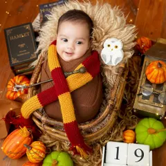 A magical three-month-old wizard. This Harry Potter themed infant shoot is a perfect way to celebrate a milestone before they can even sit up, capturing their emerging personality.