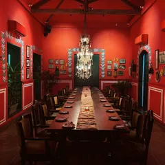 The definition of susegad. This stunning, all-red dining room in Goa is a masterclass in bold interior design and creating a mood.