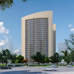 This render showcases an upcoming studio apartment building in Noida, designed for modern urban living. The distinctive curved facade creates a dynamic presence while ensuring each apartment is filled with light and space.
