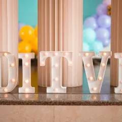A close-up of the marquee letters used at Ditvi's party, adding a personalized and illuminated touch to the decor.