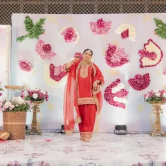 The radiant mom-to-be, perfectly framed by the floral lotus decor we created for her special day.