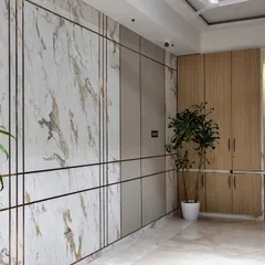 This long entryway wall is transformed into a feature with panels of marble and wood, accented with brass inlays. It's a perfect example of how to blend style and storage seamlessly.