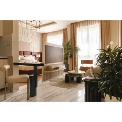 Another view of the open layout, showing how the living area and bedroom coexist harmoniously. The neutral color palette and ample natural light help make the 540 sqft space feel larger and more inviting.