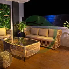 This terrace seating area is designed for ultimate relaxation. We paired comfortable, natural-fiber furniture with a vertical garden wall and potted plants to create a space that feels both stylish and connected to nature.