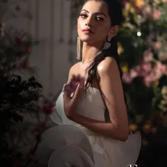 Another shot from a creative photoshoot, this time with dramatic lighting. This look showcases a soft, ethereal glam with a focus on glowing skin and defined eyes, perfect for a modern party or event.