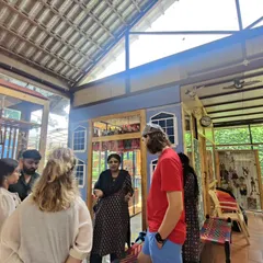 During a museum tour, I enjoy sharing the stories behind specific puppets and traditions. Here, I am speaking with a group of students about the different styles of puppets in our collection.