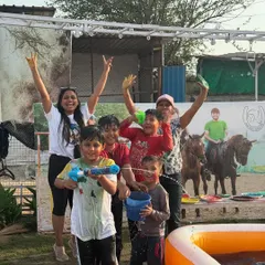Pure joy and celebration as guests, covered in colors, pose for a group photo during our Holi event.