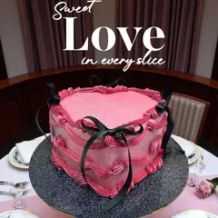 Sweet love in every slice. This vintage-style pink heart cake with black ribbon details is a unique and romantic dessert, perfect for an anniversary or special date night.